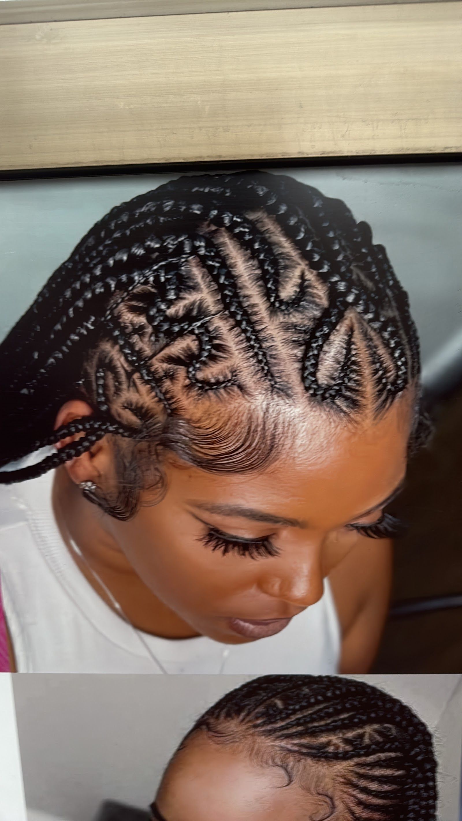 Close-up of a client's hair in a neat cornrow braid pattern